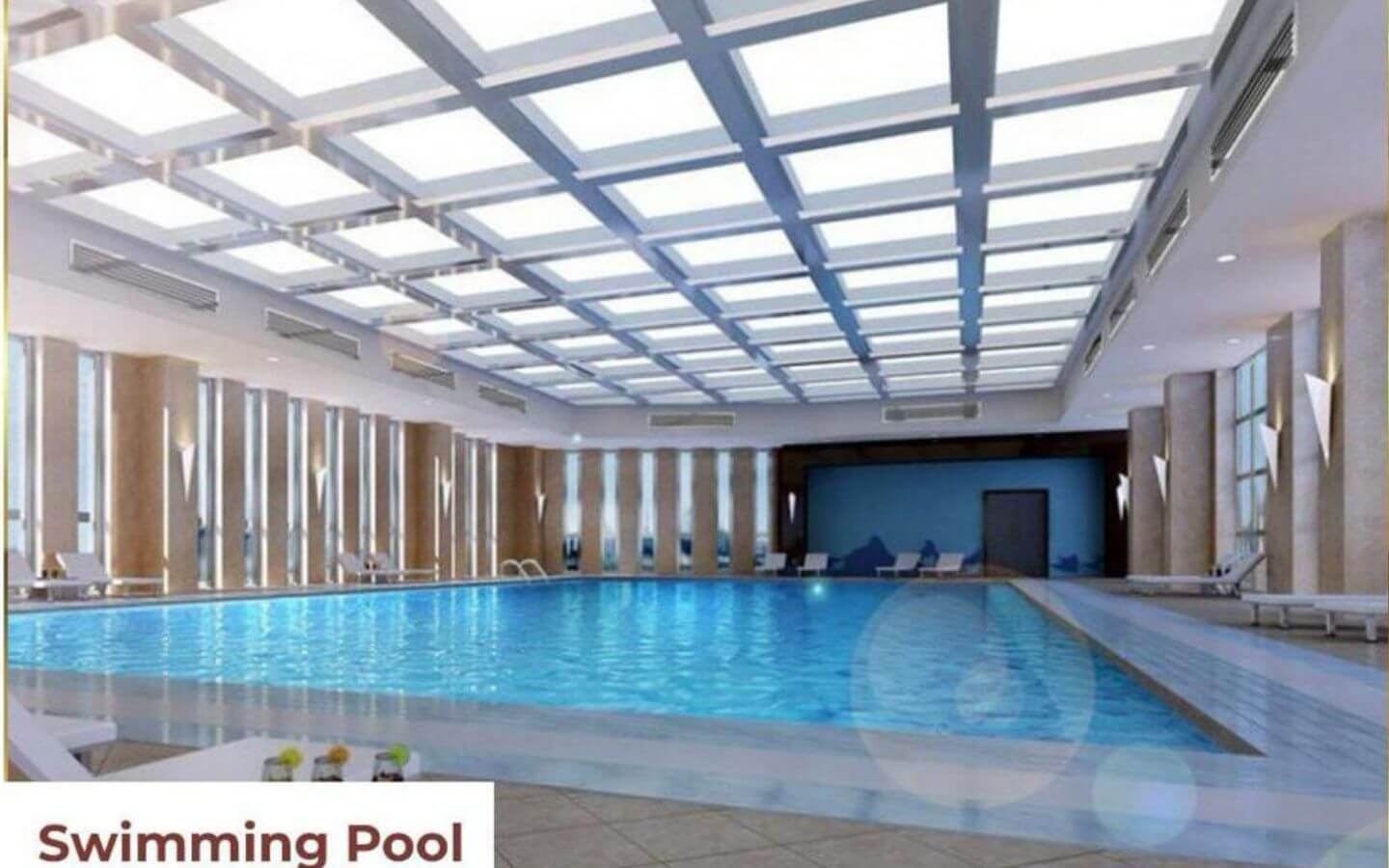 Modern indoor swimming pool with glass-paneled ceiling, azure blue water, and lounge chairs